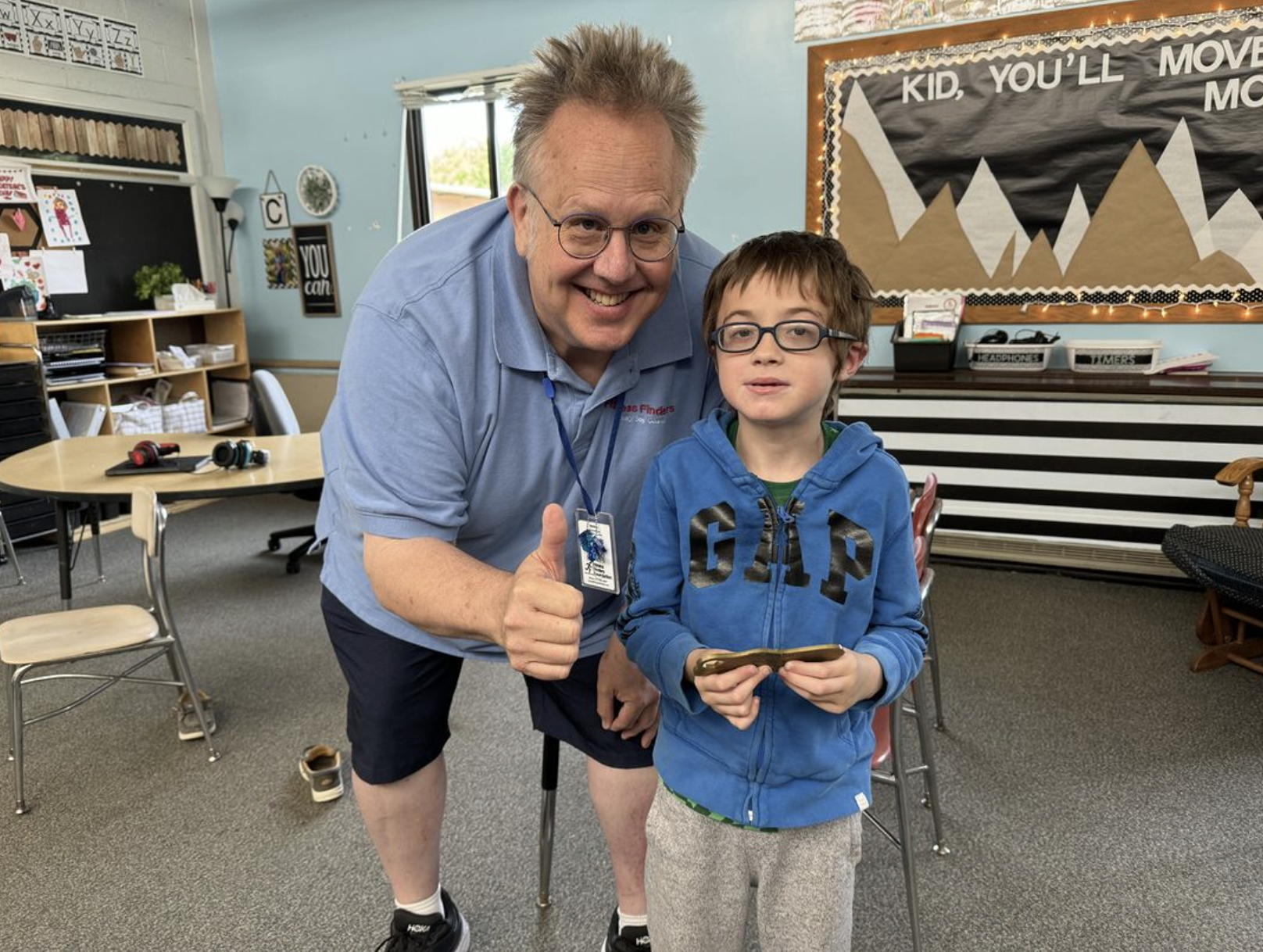 Woodworth Elementary School kindergartner Kingsley Baer with Fitness Finders sales associate Scott Sundberg